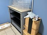 many boxes and bags sitting on the floor in the room
