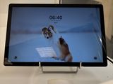 a tablet computer on a table with a picture of a dog on the screen