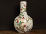 a white vase with flowers and birds painted on it