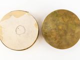 pair of antique brass buttons on a white background