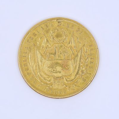 a gold coin on a white surface with a white background