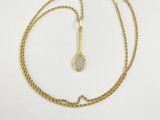 a gold chain bracelet with a small diamond on the clasp