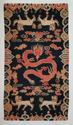 an oriental rug with a red dragon on a black background