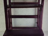 a wooden step stool with a wooden seat on a white surface