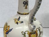a white vase with a yellow and blue design on it