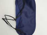a close up of a blue eye mask on a white surface