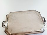 rectangular silver tray with handles on a white surface