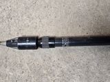 a close up of a pen laying on the ground with a pen in it