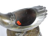 a silver bird statue with a red tag on it