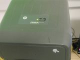 a printer sitting on top of a stack of boxes