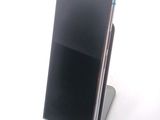a cell phone that is sitting on top of a stand