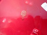 a red plate that has a sticker on it