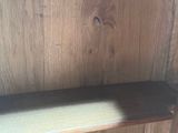 a wooden shelf with two shelves on top of it