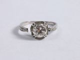 a close up of a diamond ring on a white surface