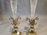 pair of gold plated candlesticks with glass vases on stands