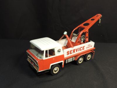 a red and white toy truck with a crane on it