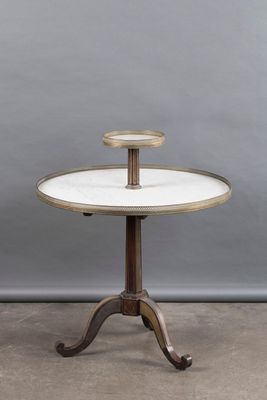 a white marble topped table on a pedestal with a wooden base