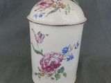 a white container with flowers on it on a table