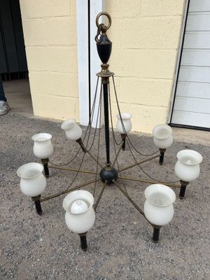 a chandelier made out of glass with a black vase on top