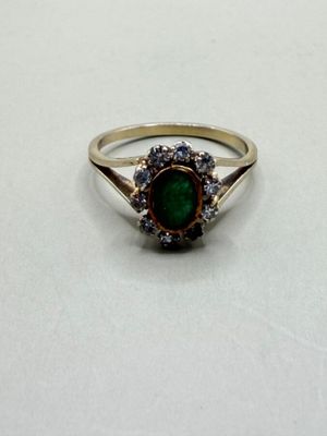 an image of a ring with a green stone in it