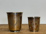 two cups that are sitting on a wooden table