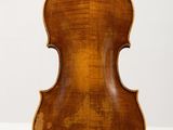 an antique violin on display in a museum