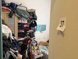 a closet full of clothes in a small room