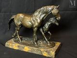 bronze statue of a horse and a foal on a marble base