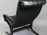 pair of black leather lounge chairs with black leather upholstered seats