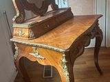a wooden table with a mirror on top of it