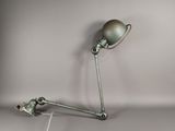 a lamp that is sitting on a table next to a wall