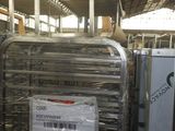 un homme debout à côté d'une pile de bagages dans un entrepôt