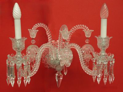 a crystal candle holder with two candles on it