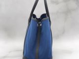 a blue and black handbag sitting on top of a marble counter