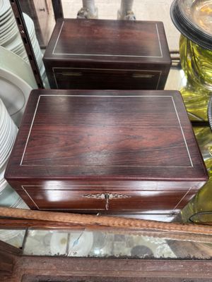 a glass table with a wooden box on top of it
