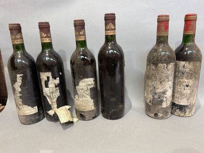 several bottles of wine are lined up on a table
