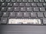 a close up of a laptop keyboard with a sticker on it