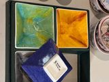 a tray that has different colored dishes and cups on it