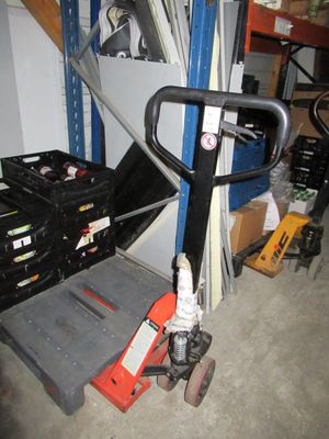 a picture of a forklift in a garage next to a stack of boxes