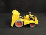a yellow toy tractor with a man sitting in it