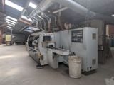 a machine that is working on a piece of wood in a building