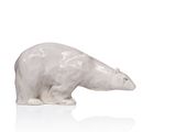 a white polar bear figurine sitting on a white surface