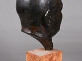 sculpture of a man ' s head on a marble base