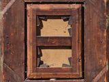 a picture of an old wooden window with a broken glass