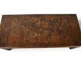 a wooden table with a carved design on it