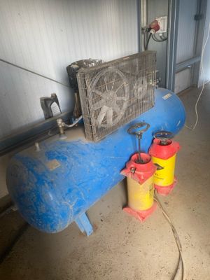 a blue tank with a fan next to a yellow can