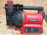 a red blower sitting on top of a piece of plywood