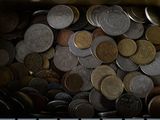a lot of coins sitting in a bin on the keyboard