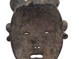 an image of a wooden mask with horns on a white background