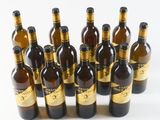 six bottles of beer are lined up in a row on a white surface